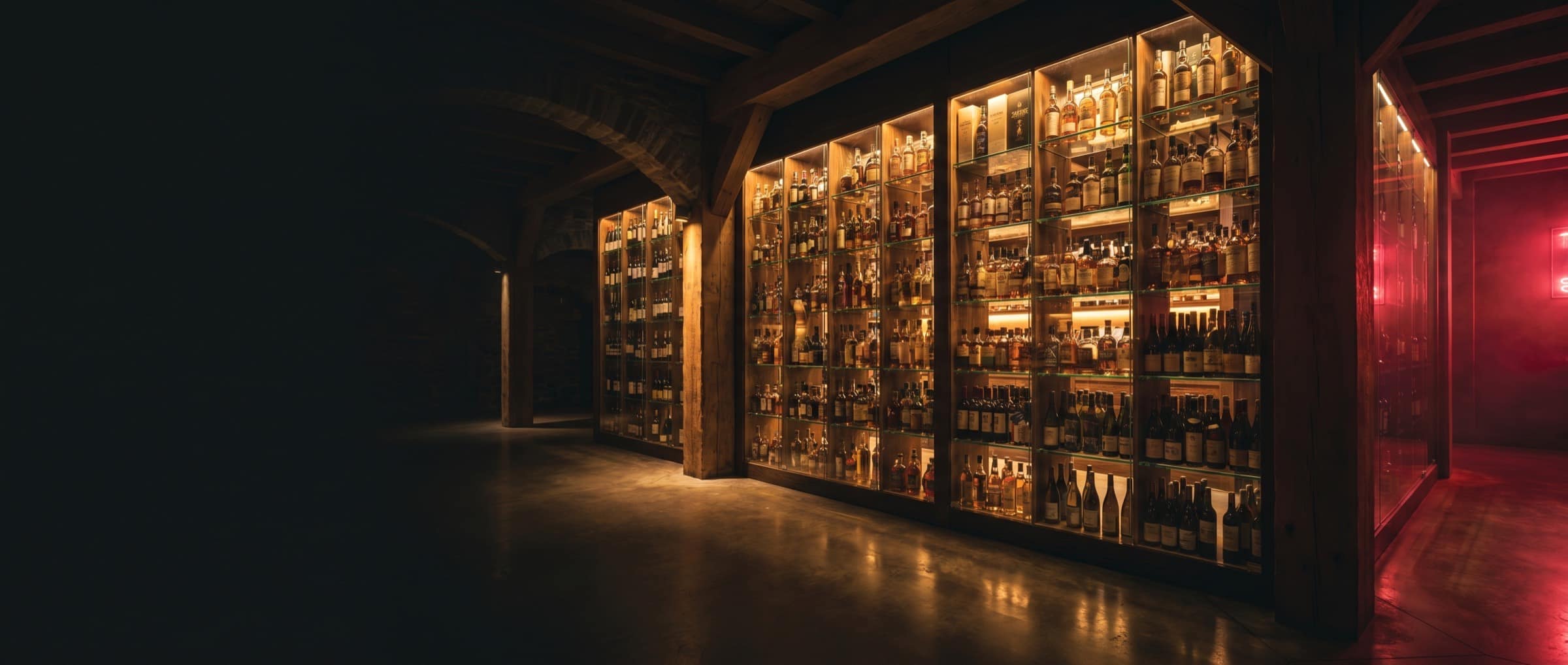 Backlit shelves of wine and spirits bottles